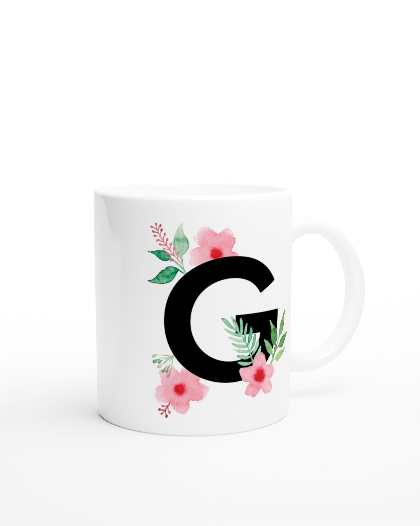 Weiße Keramiktasse mit schwarzem Buchstaben G und rosa-grünen Aquarell-Blumen
