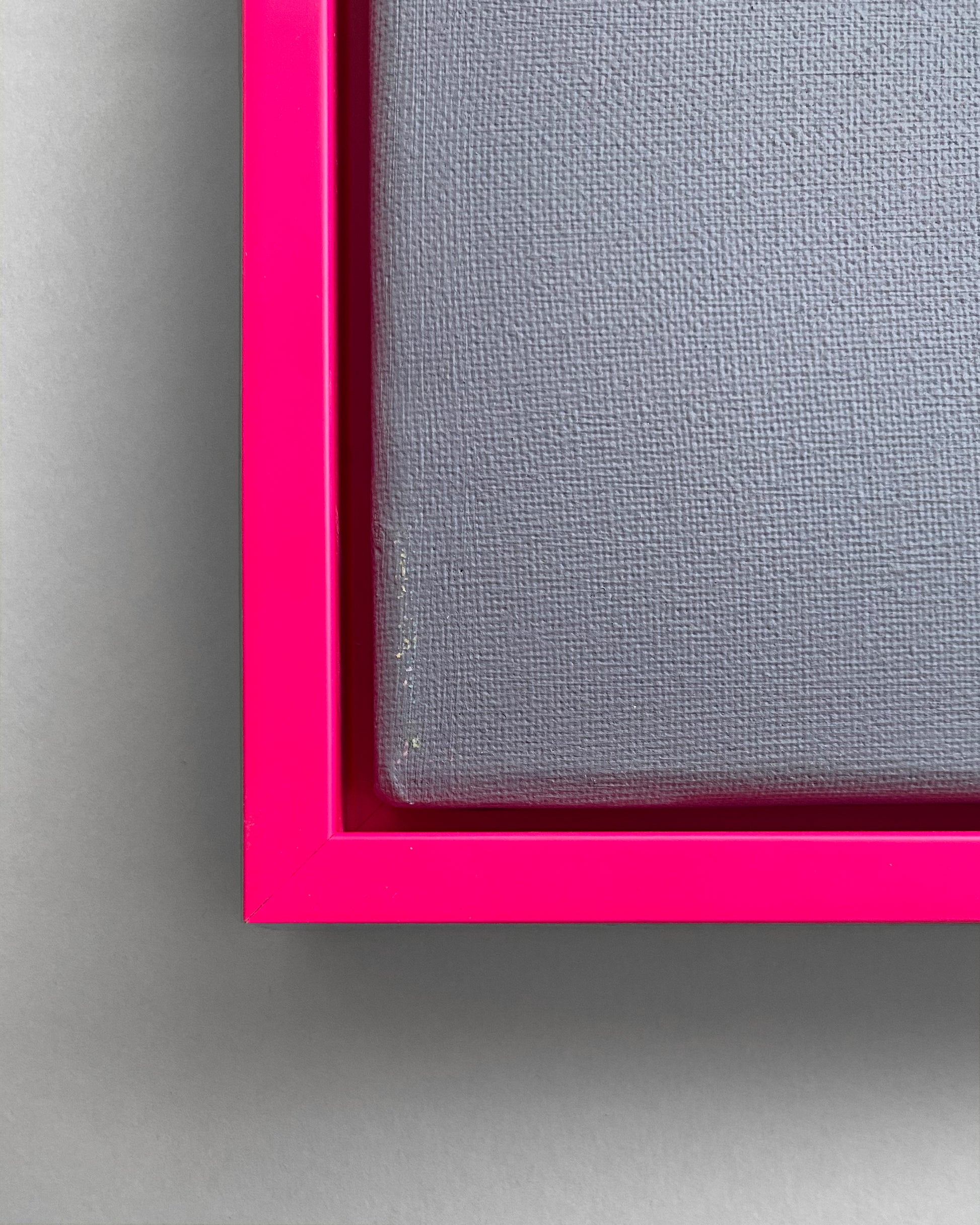 Detail des Schattenfugen-Rahmens in Neon Pink mit einer grauen Leinwand