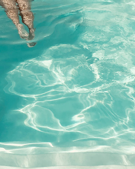 Detailausschnitt des Posters The Pool Girl - Wellenstruktur und Beine einer Frau im Anschnitt